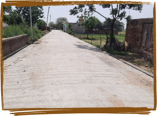 Image showcasing the construction of an all-weather road in a rural area, enhancing accessibility.